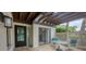 Inviting patio with table and chairs, accessed through sliding glass doors at 3102 Windrush Bourne # 4, Sarasota, FL 34235