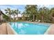 Community pool with lounge chairs, perfect for relaxing and enjoying the sun at 3102 Windrush Bourne # 4, Sarasota, FL 34235