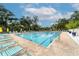 Beautiful community pool with lounge chairs and shade umbrellas for relaxing by the crystal clear water at 3102 Windrush Bourne # 4, Sarasota, FL 34235