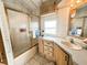 Clean bathroom with a shower and wood cabinets at 3333 26Th E Ave # 1116, Bradenton, FL 34208