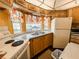Kitchen with light wood cabinets and double sink at 3333 26Th E Ave # 1116, Bradenton, FL 34208
