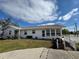 White single-story home with a carport and landscaped yard at 3517 Bahia Vista St, Sarasota, FL 34239