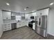 Modern kitchen with white cabinets, stainless steel appliances, and gray floors at 3517 Bahia Vista St, Sarasota, FL 34239