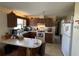 Kitchen features wood cabinets, a breakfast bar, and white appliances at 3517 Bahia Vista St, Sarasota, FL 34239