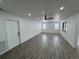 Bright and airy living room with gray vinyl plank flooring and ceiling fan at 3517 Bahia Vista St, Sarasota, FL 34239