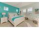 Spacious bedroom with a large bed, teal accents, and plenty of natural light at 379 Aruba Cir # 301, Bradenton, FL 34209