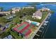 Aerial view of community tennis courts, pool, and marina at 3860 Mariners Way # 413, Cortez, FL 34215