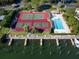 Aerial view of tennis and pickleball courts, pool, and marina at 3860 Mariners Way # 413, Cortez, FL 34215