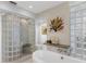 Spa-like bathroom with glass shower, soaking tub, and modern fixtures at 3860 Mariners Way # 413, Cortez, FL 34215