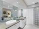 Elegant bathroom with double sinks and glass block shower at 3860 Mariners Way # 413, Cortez, FL 34215
