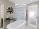 Spa-like bathroom with a freestanding tub and glass block wall at 3860 Mariners Way # 413, Cortez, FL 34215