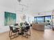 Elegant dining room with glass table, modern chairs, and hardwood floors at 3860 Mariners Way # 413, Cortez, FL 34215