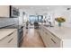 Modern kitchen with granite countertops, stainless steel appliances, and hardwood floors at 3860 Mariners Way # 413, Cortez, FL 34215