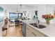 Modern kitchen with granite countertops, island, and stainless steel appliances at 3860 Mariners Way # 413, Cortez, FL 34215