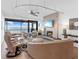 Open living room with fireplace, water view, and ample seating at 3860 Mariners Way # 413, Cortez, FL 34215