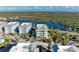 Aerial view of condo building near water with parking and tropical foliage at 395 Aruba Cir # 302, Bradenton, FL 34209