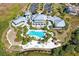 Aerial view of community clubhouse, pool, and surrounding landscape at 395 Aruba Cir # 302, Bradenton, FL 34209