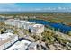 Aerial view of waterfront condo building with parking and landscaping at 395 Aruba Cir # 302, Bradenton, FL 34209