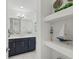 Modern bathroom with dark vanity and floating shelves at 395 Aruba Cir # 302, Bradenton, FL 34209