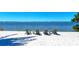 Scenic waterfront view with comfortable Adirondack chairs at 395 Aruba Cir # 302, Bradenton, FL 34209