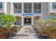 Ground level condo entrance with landscaping and building name at 395 Aruba Cir # 302, Bradenton, FL 34209