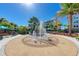 Community water fountain with palm trees and building in background at 395 Aruba Cir # 302, Bradenton, FL 34209