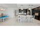 Open kitchen features an island with seating and dark wood cabinets at 395 Aruba Cir # 302, Bradenton, FL 34209
