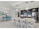 Modern kitchen with island, stainless steel appliances, and dark cabinets at 395 Aruba Cir # 302, Bradenton, FL 34209