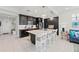 Spacious kitchen with dark cabinetry, an island, and stainless steel appliances at 395 Aruba Cir # 302, Bradenton, FL 34209
