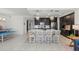 Open kitchen with island, stainless steel appliances, and dark cabinetry at 395 Aruba Cir # 302, Bradenton, FL 34209