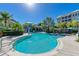 Community pool with surrounding lounge chairs at 395 Aruba Cir # 302, Bradenton, FL 34209