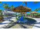 Relaxing outdoor seating area with thatched umbrellas at 395 Aruba Cir # 302, Bradenton, FL 34209
