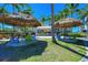 Covered seating area with thatched umbrellas and tables at 395 Aruba Cir # 302, Bradenton, FL 34209