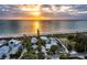 Aerial view of beach house and neighborhood at sunset at 409 Casey Key Rd, Nokomis, FL 34275