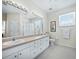 Bathroom with double vanity, sink, and shower at 409 Casey Key Rd, Nokomis, FL 34275