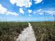 Sandy pathway leading to the beach at 409 Casey Key Rd, Nokomis, FL 34275