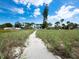 Sandy path to the beach, home view in background at 409 Casey Key Rd, Nokomis, FL 34275