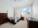 Bedroom with post bed, dresser, and desk at 409 Casey Key Rd, Nokomis, FL 34275