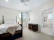 Bedroom with post bed, desk, and ensuite bathroom at 409 Casey Key Rd, Nokomis, FL 34275