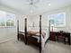 Bedroom with post bed and desk at 409 Casey Key Rd, Nokomis, FL 34275
