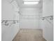 Spacious walk-in closet with wire shelving and hanging rods at 409 Casey Key Rd, Nokomis, FL 34275