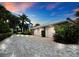 Three-car garage with brick paver driveway at 409 Casey Key Rd, Nokomis, FL 34275
