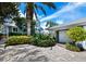 Cobblestone driveway, lush landscaping, and garage at 409 Casey Key Rd, Nokomis, FL 34275
