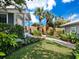 Landscaped front yard with walkway to charming home at 409 Casey Key Rd, Nokomis, FL 34275