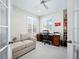 Home office with built-in shelving and comfortable seating at 409 Casey Key Rd, Nokomis, FL 34275
