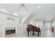 Living area with fireplace, tiled floors, and a grand piano at 409 Casey Key Rd, Nokomis, FL 34275