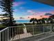 Stunning sunset view from balcony overlooking the ocean at 409 Casey Key Rd, Nokomis, FL 34275