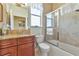Bathroom with granite countertop, shower/tub combo, and wood cabinets at 4111 Hemingway Dr, Venice, FL 34293