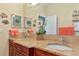 Double vanity bathroom with granite countertops and decorative accents at 4111 Hemingway Dr, Venice, FL 34293
