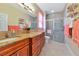 Double vanity bathroom with granite countertops and a walk-in shower at 4111 Hemingway Dr, Venice, FL 34293